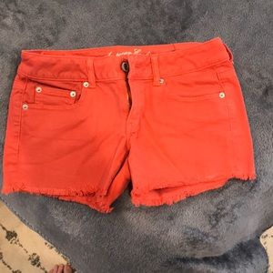 Red ripped jean shorts